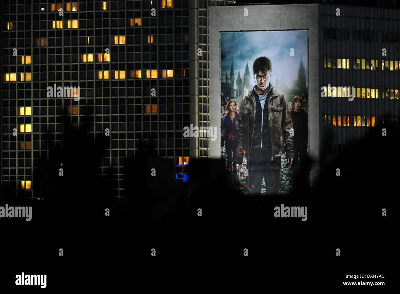 A giant image of Harry Potter is placed at Berlin Alexanderplatz, Germany, 14 July 2011. The poster is an advertisement for the new and last Harry Potter movie currently screened in cinemas in Berlin. Photo: Maurizio Gambarini Stock Photo