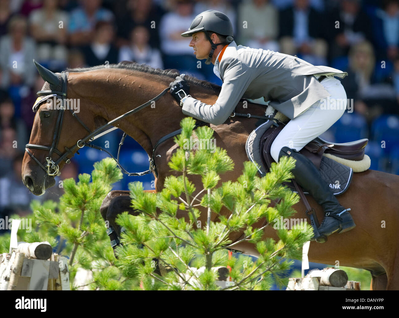 German equestrian Marco Kutscher jumps with his horse Cash during the