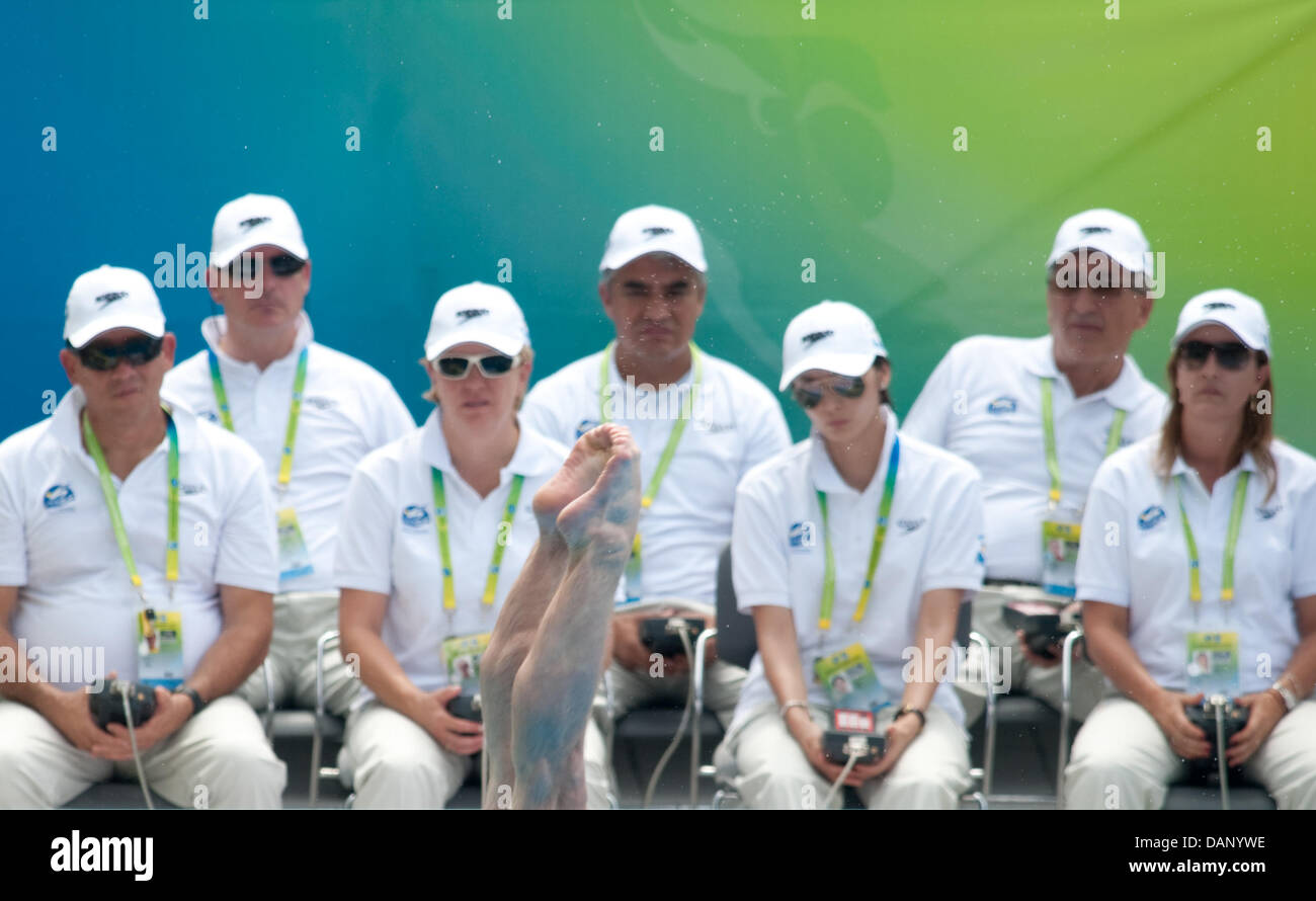 A competitor performs in front of the judges during the men's 1m