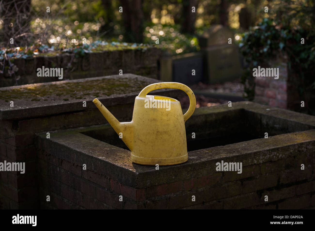 Germany, North Rhine Westphalia, Cologne, Watering can at cemetery Melatenfriedhof Stock Photo