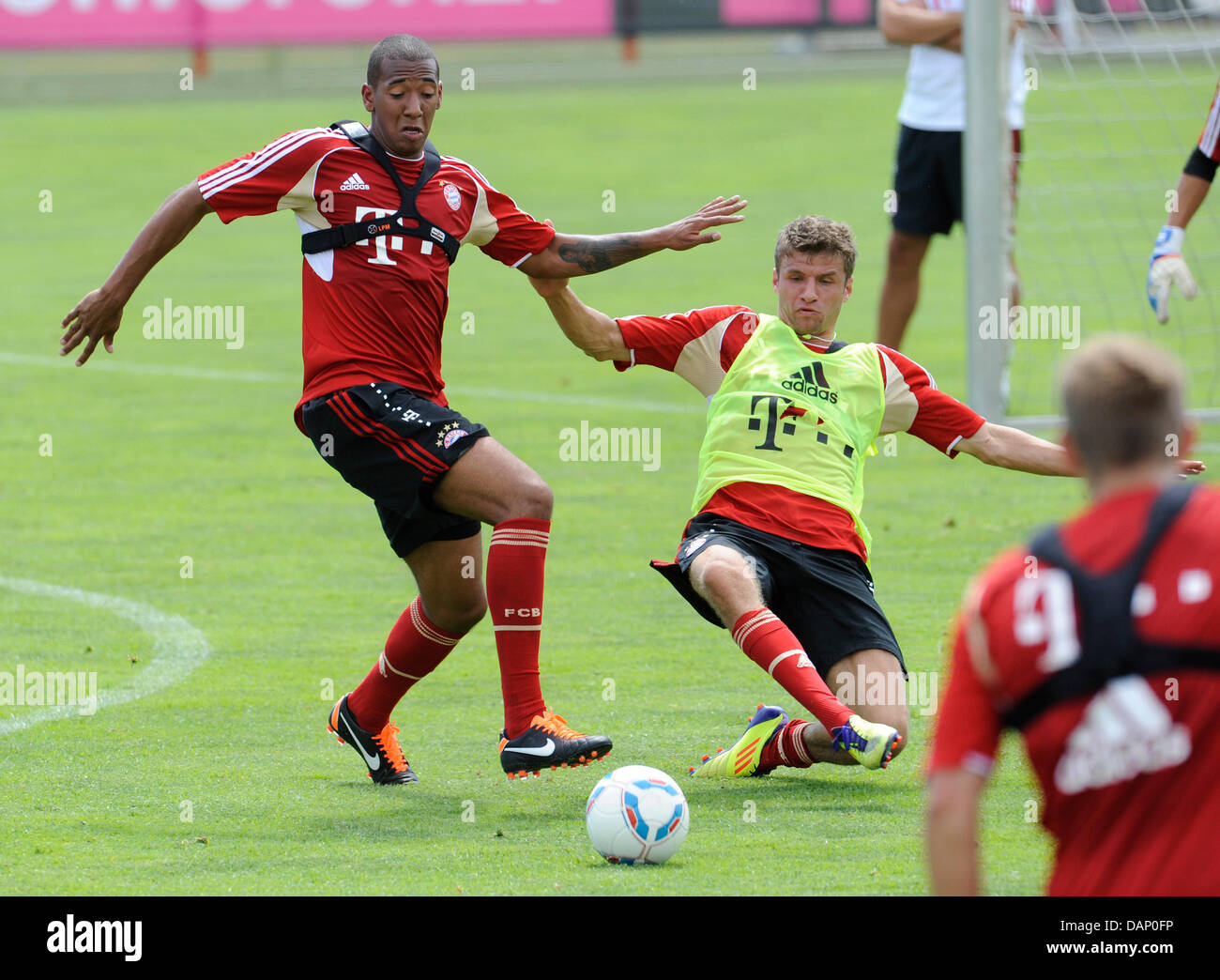 New FC Bayern Munich player Jerome Boateng (L) and Thomas Mueller vie for the ball during practice at the Bundesliga club's trainig facilities in Munich, Germany, 17 July 2011. The 19-year-old Japanese player will be on loan this season. Photo: Andreas Gebert Stock Photo