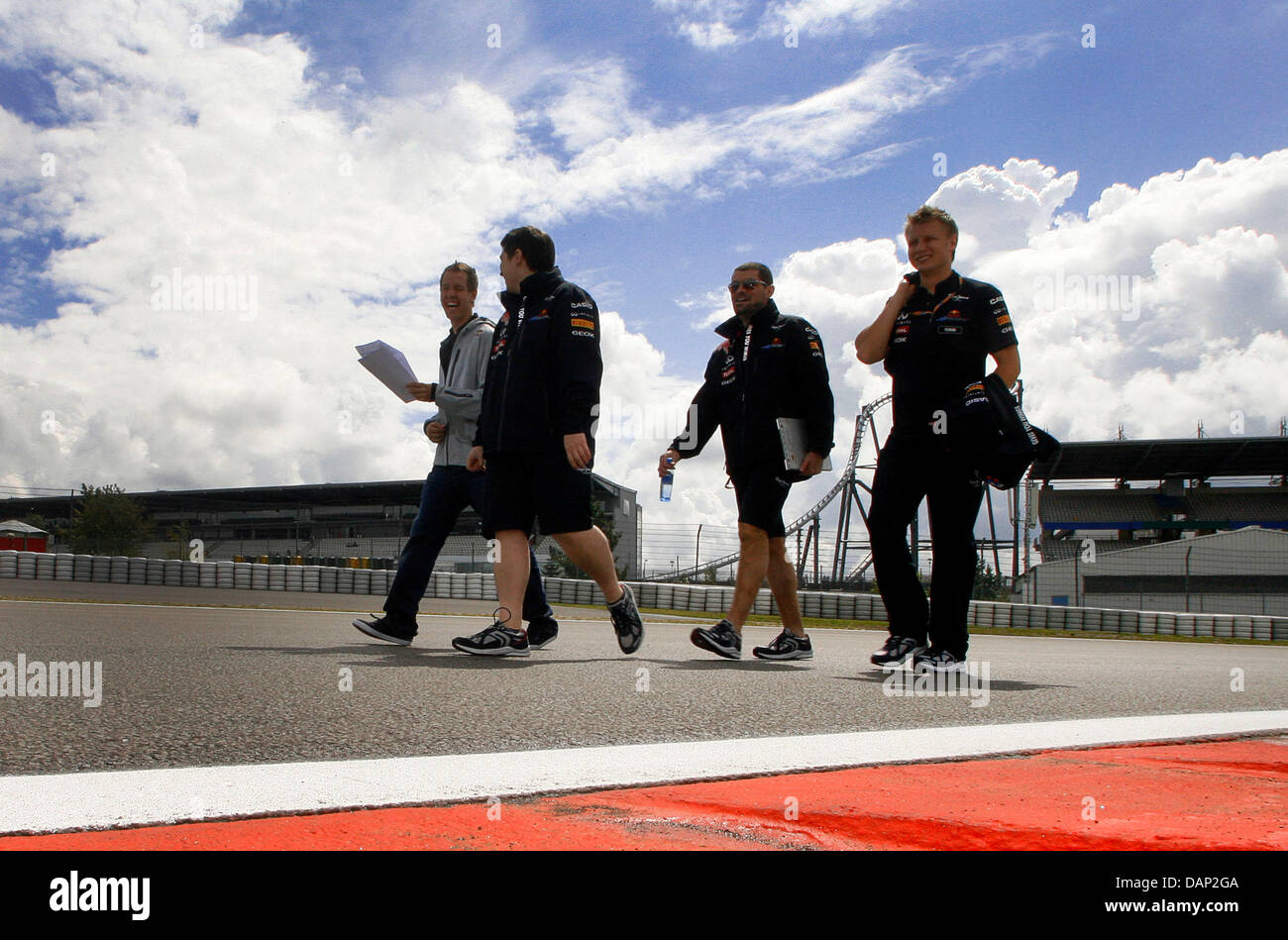 German Formula One driver Sebastian Vettel (L) of Red Bull walks on the F1 race track of Nuerburgring, Nuerburg, 21 July 2011. The Formular One Grand Prix of Germany will take place on 24 July. Photo: Roland Weihrauch dpa/lrs  +++(c) dpa - Bildfunk+++ Stock Photo