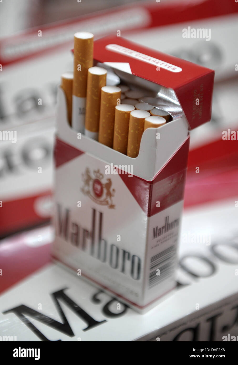 A fake package of Marlboro cigarettes without revenue stamp stands on other fake cigarette parcels at a warehouse in Hamburg, Germany, 21 July 2011. The customs investigation office seizured 13 million cigerettes. Photo: CHRISTIAN CHARISIUS Stock Photo