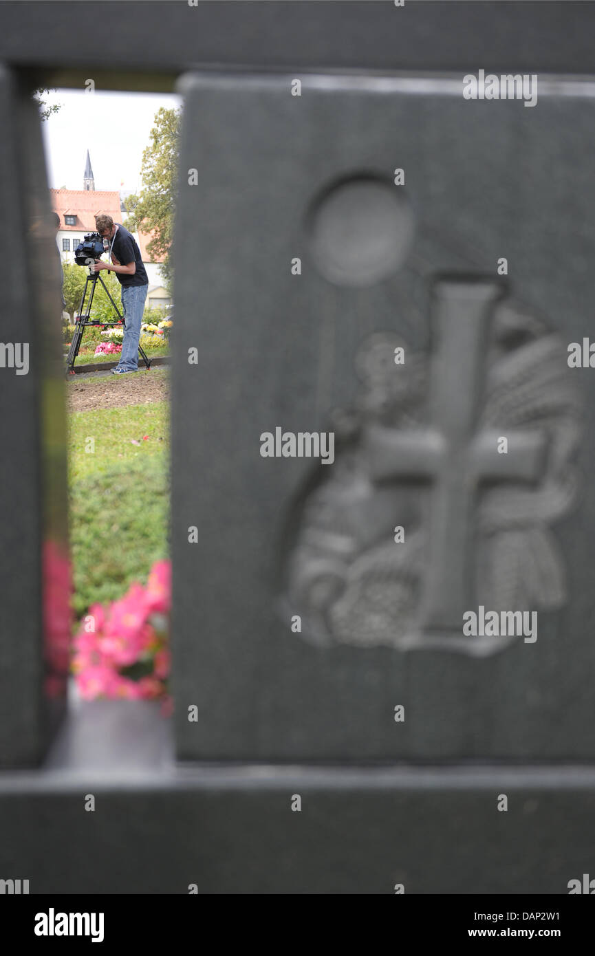 A camera man films the spot, where the grave of Adolf Hitler's Deputy Rudolf Hess (1894-1987) was previously situated at the cemetery in Wunsiedel, Germany, 21 July 2011. For more than two decades, the grave was a place of pilgrimmage for neo-nazis and right-wing extremists. The remains of Rudolf Hesse have been exhumed and his grave destroyed. Hess's remains are to be cremated and Stock Photo