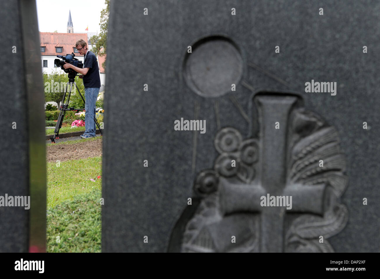 A camera man films the spot, where the grave of Adolf Hitler's Deputy Rudolf Hess (1894-1987) was previously situated at the cemetery in Wunsiedel, Germany, 21 July 2011. For more than two decades, the grave was a place of pilgrimmage for neo-nazis and right-wing extremists. The remains of Rudolf Hesse have been exhumed and his grave destroyed. Hess's remains are to be cremated and Stock Photo