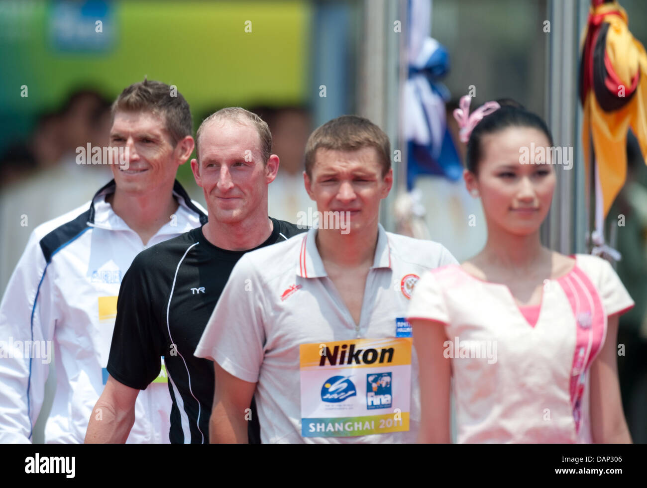 Thomas Lurz (2nd L) from Germany on the way to the medal ceremony for the 5km open water event at the 2011 FINA World Swimming Championships, Shanghai, China, 22 July 2011. Lurz gained the first place and won gold, Spyros Giannotis (R) from Greece became second, Jevgenij Drattsev (2.R) from Russia third. Photo: Bernd Thissen dpa  +++(c) dpa - Bildfunk+++ Stock Photo