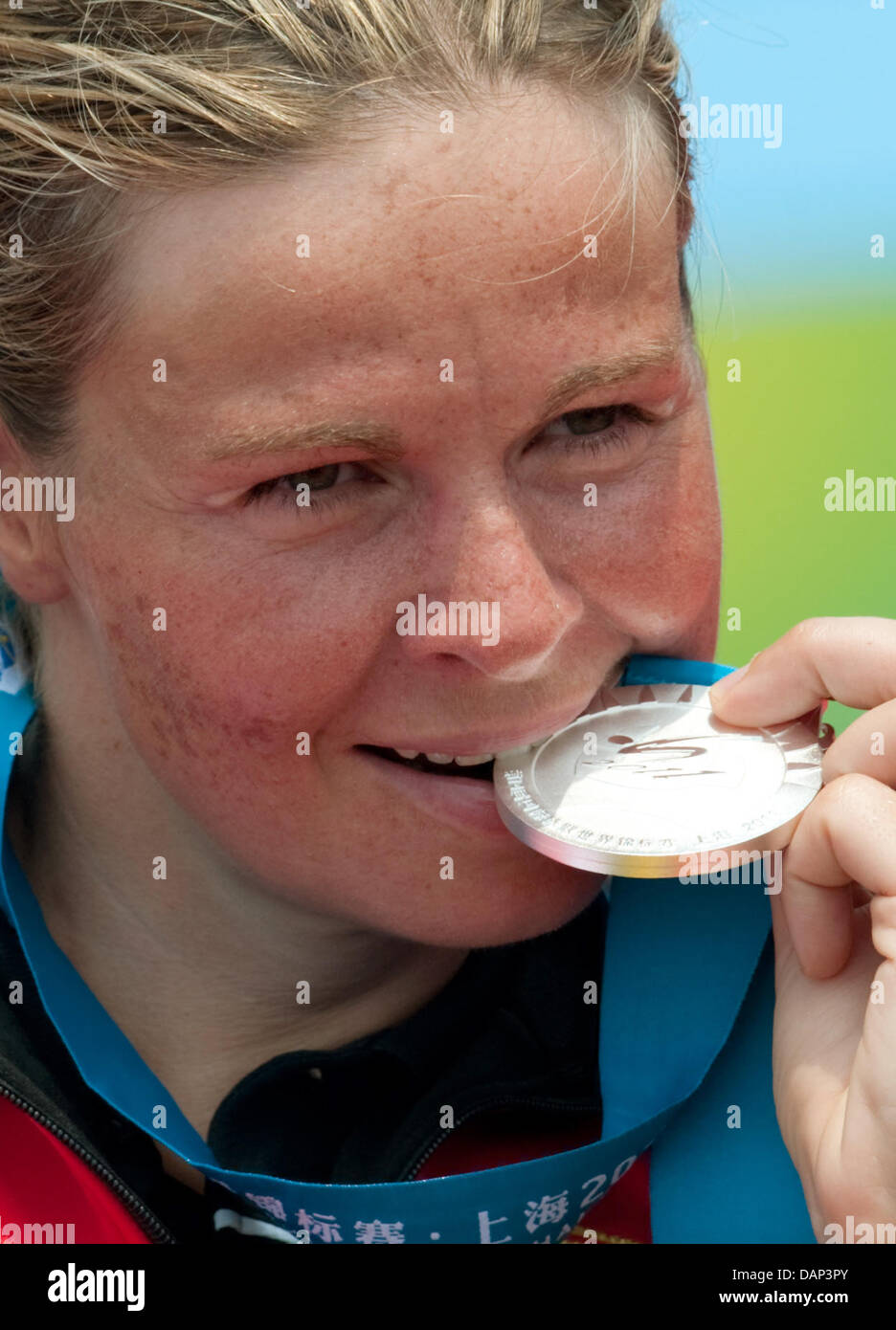 Angela Maurer from Germany bites her silver medal after the women's 25