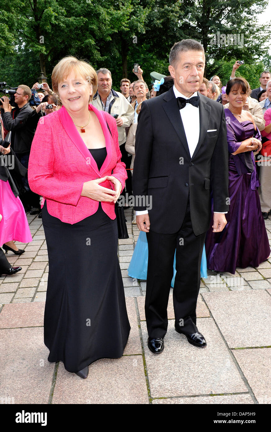 German Chancellor Angela Merkel (CDU) and her husband Joachim Sauer leave the theater during the break at the opening of the Bayreuth Festival 2011 in Bayreuth, Germany, 25 July 2011. The 100th festival opens with the opera 'Tannhaeuser'. The one-month festival is Germany's most prestigious culture event and devoted to operas by Richard Wagner. Photo: Ursula Düren dpa/lby Stock Photo