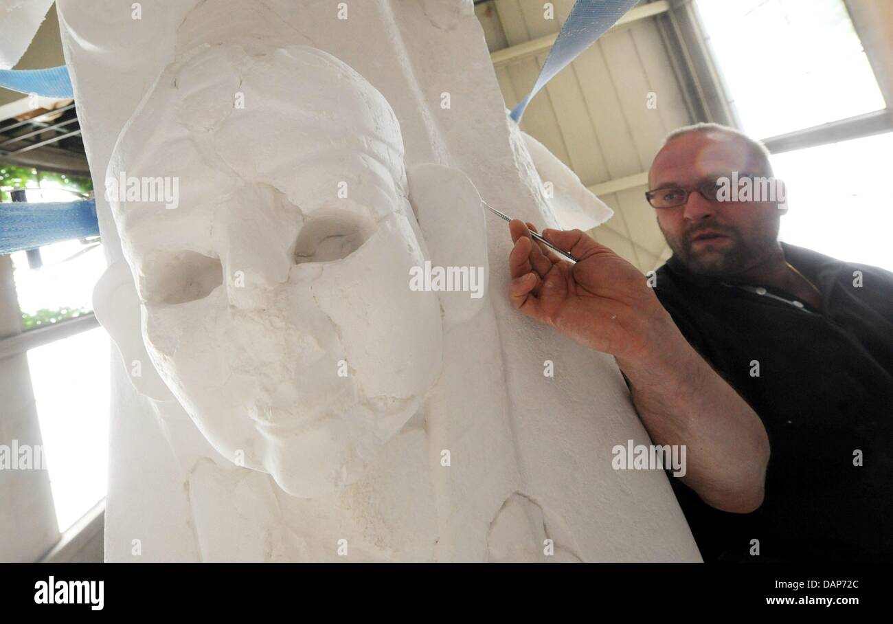 Plaster artist Sandro DiMichele works on a copy of the sphinx from