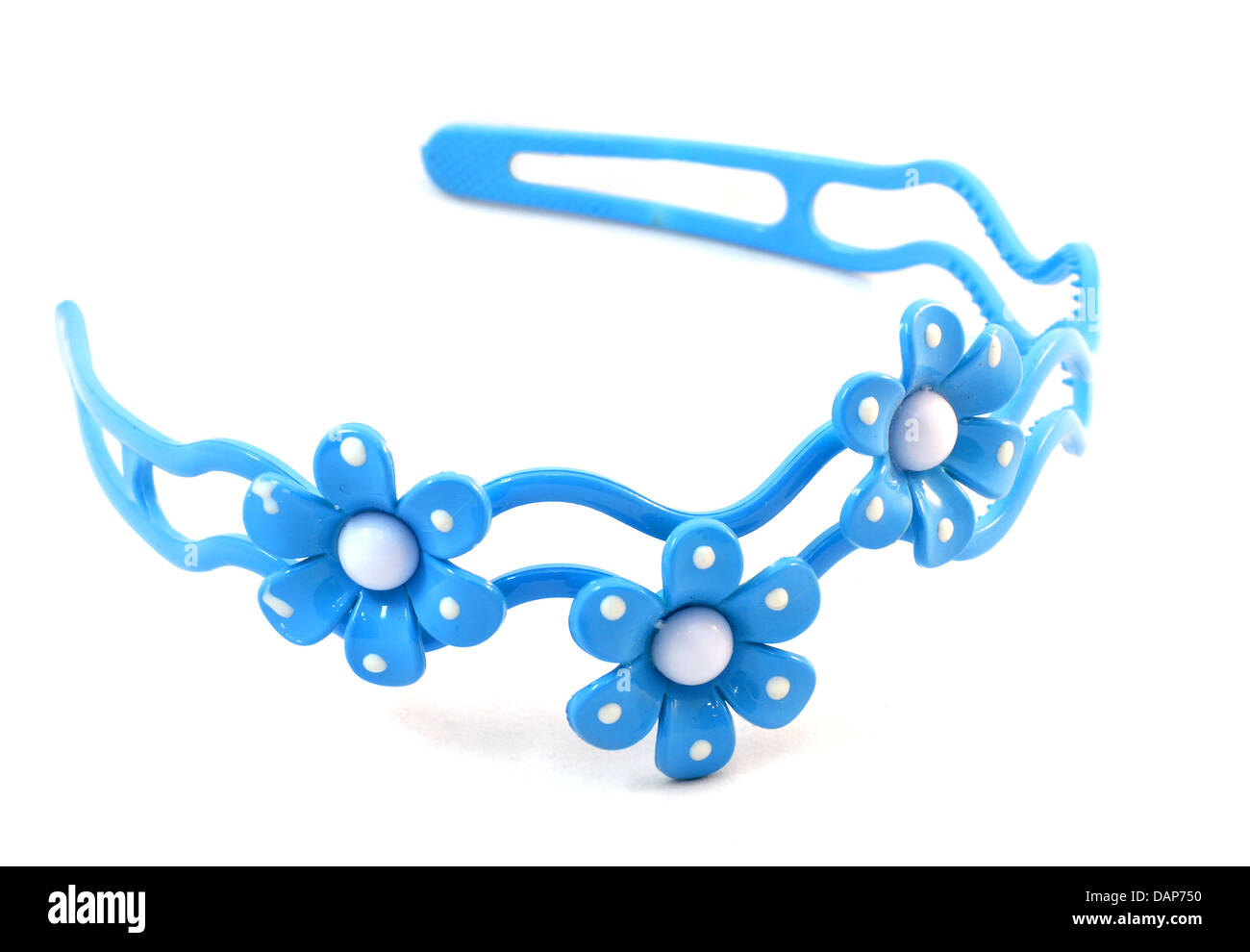Blue plastic hair band with three flowers on white background Stock Photo