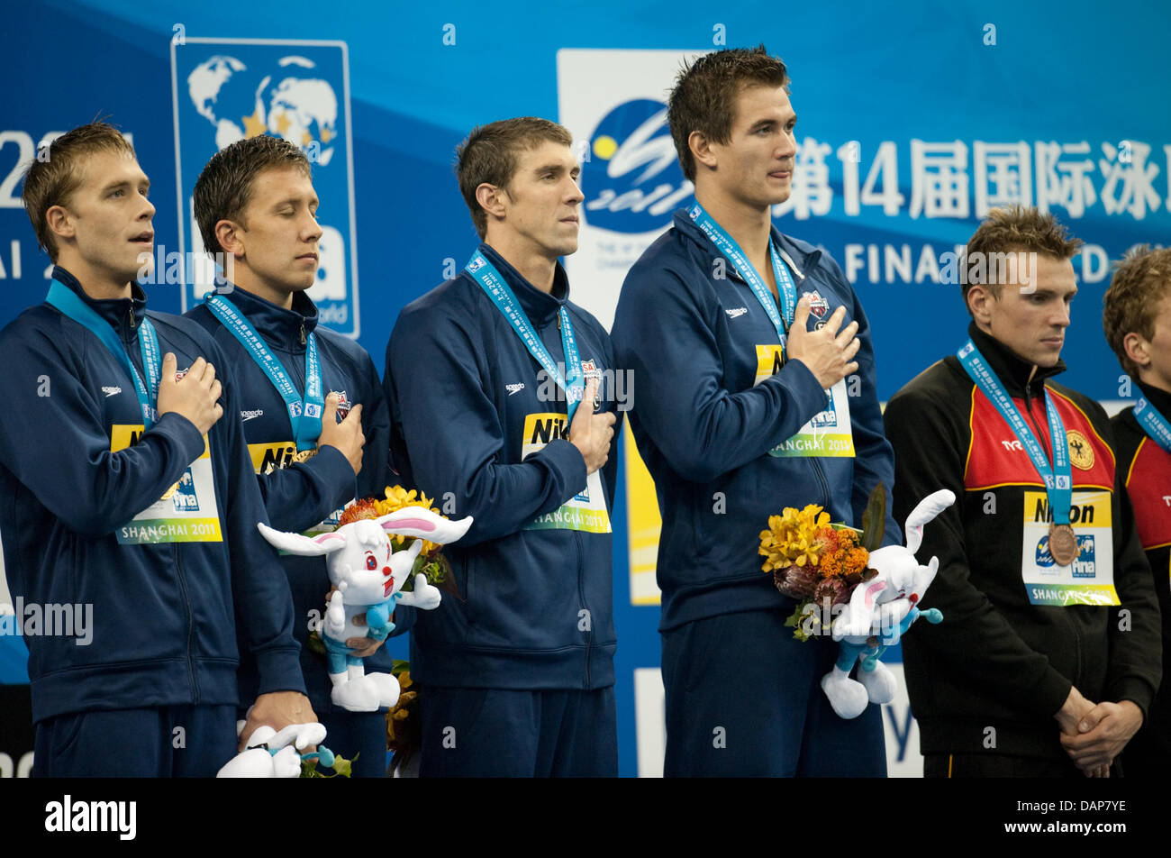 (L-R) Gold medalists Nicholas Thoman, Mark Gangloff, Michael Phelps and Nathan Adrian of the USA and Germany's Paul Biedermann attend the medal ceremony after the 4x100 Individual Medley Relay at the 2011 FINA World Swimming Championships, Shanghai, China, 31 July 2011. USA won gold, Germany bronze. Photo: Bernd Thissen dpa  +++(c) dpa - Bildfunk+++ Stock Photo