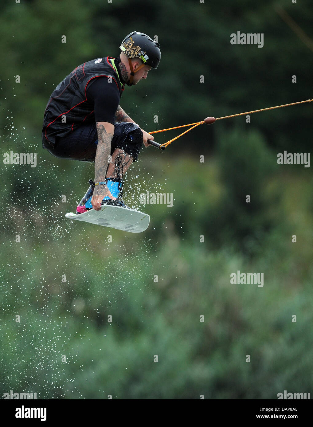 A man jumps during water skiing at the Blue Lake in Hanover Garbsen, Germany, 01 August 2011. Photo: Caroline Seidel Stock Photo