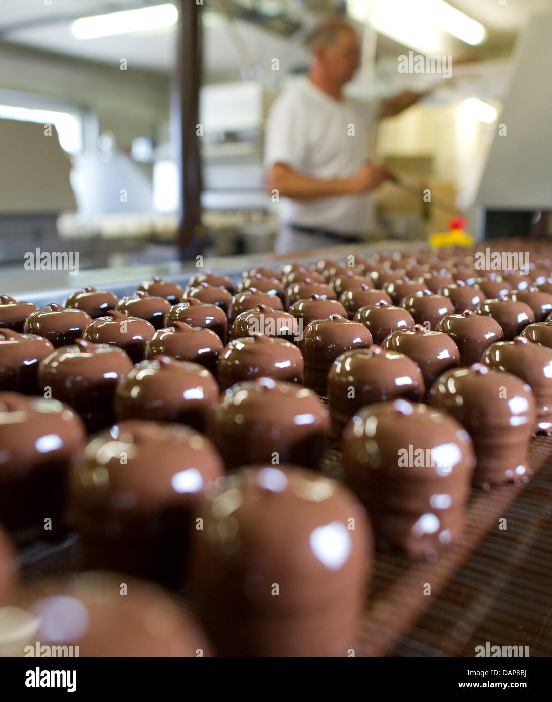A staff member checks the production of chocolate marshmallows at the factory of sweets manufacturer 'Trauth' in Herxheim near Landau, Germany, 07 July 2011. Photo: Uwe Anspach Stock Photo