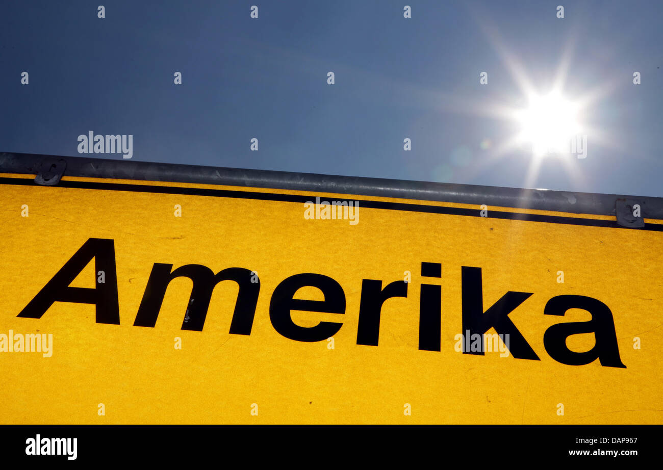 The sun shines above a place name sign of the town Amerika in Germany, 02 August 2011. The small village belongs to the city Penig in Germany. Photo: Jan Woitas Stock Photo