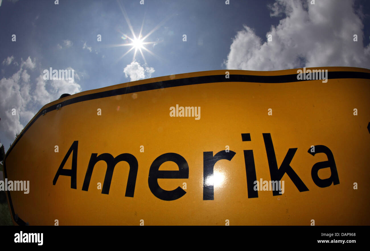 The sun shines above a place name sign of the town Amerika in Germany, 02 August 2011. The small village belongs to the city Penig in Germany. Photo: Jan Woitas Stock Photo