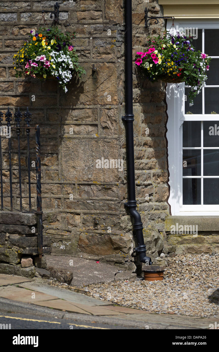 Hanging baskets at front of cottage in Haws North Yorkshire Stock Photo