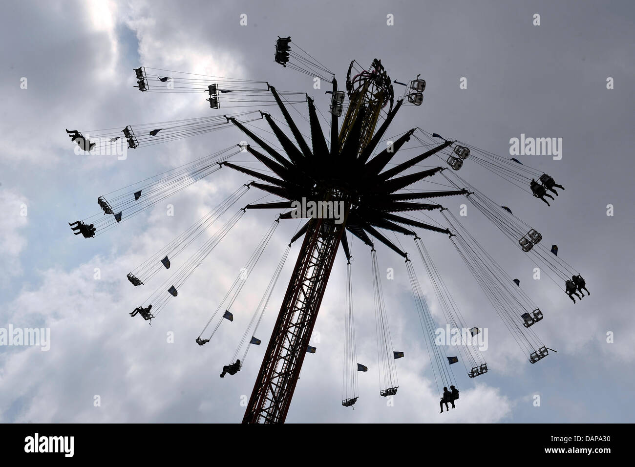 Visitors ride the swing carousel at the Cranger Kirmes fair in Herne, Germany, 05 August 2011. Around four million visitors are expected by the organizers until 14 August 2011, therefore, the folks festival is one of the best attended in Germany. Photo: MARIUS BECKER Stock Photo