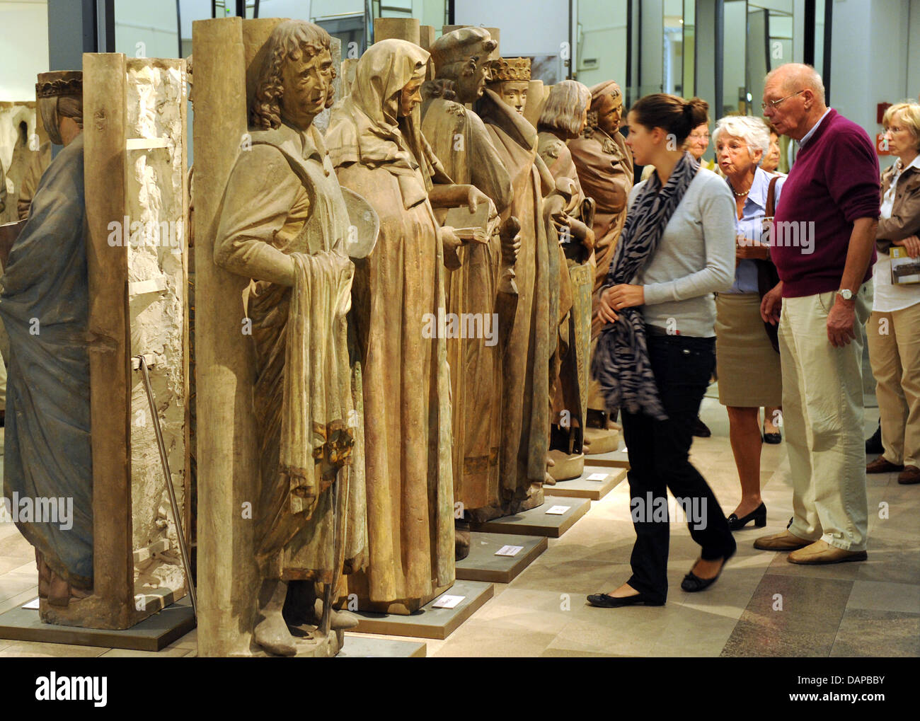 FILE - An archive picture dated 02 August 2011 shows visitors viewing the figures of the eleven founders from the west choir of the Naumburg Cathedral at the state exhibiton 'The Naumburg Master - sculptor and architect in the Europe of Cathedrals' ('Der Naumburger Meister - Bildhauer und Architekt im Europa der Kathedralen') at the 'hall of mirrors' of the city museum in Naumburg, Stock Photo