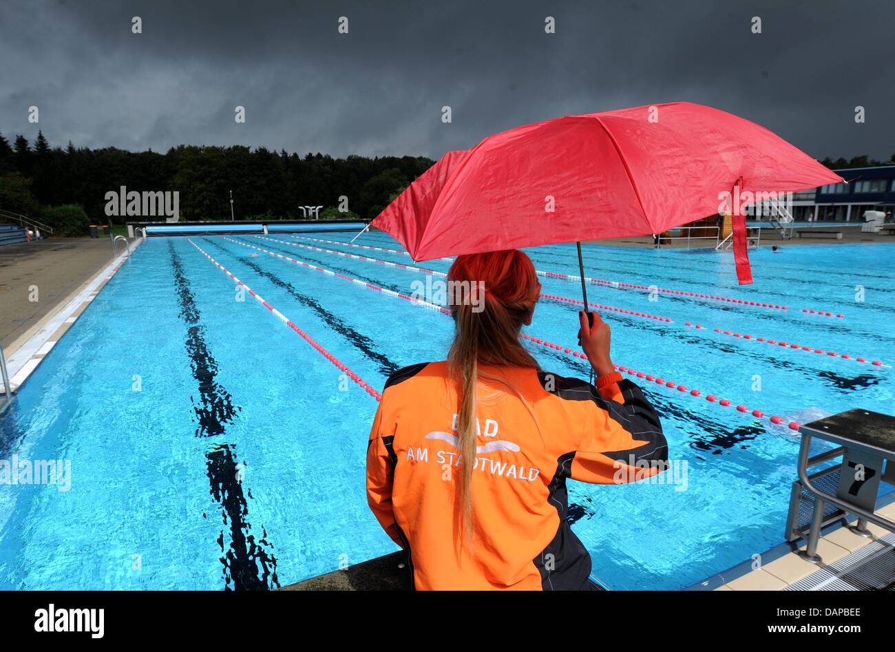 A pool attendant watches the almost empty openair bath Stadtwald