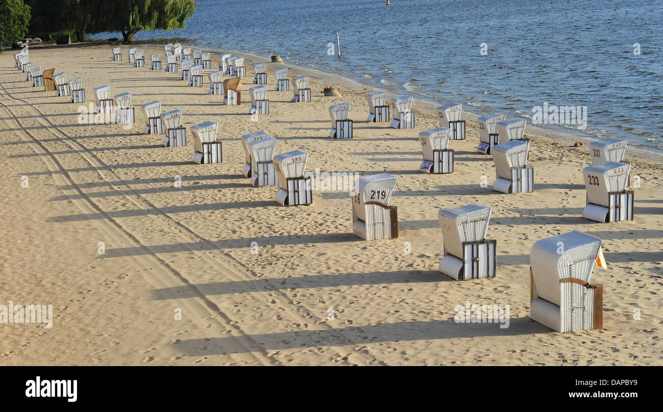 Beach chairs cast long shadows at the lido Wannsee in Berlin, Germany, 09 August 2011. Photo: Jens Kalaene Stock Photo