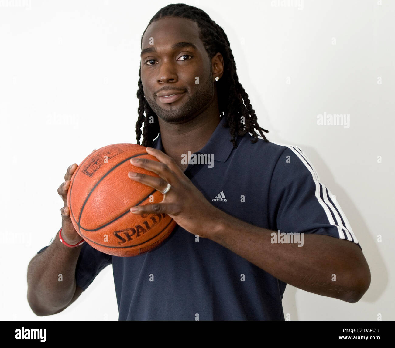 US basketball player Torin Francis poses with a basketball in Berlin, Germany, 10 August 2011. Torin and Simonovic are new players of Alba Berlin and will present their skills in the coming season in Berlin. Photo: Britta Pedersen Stock Photo