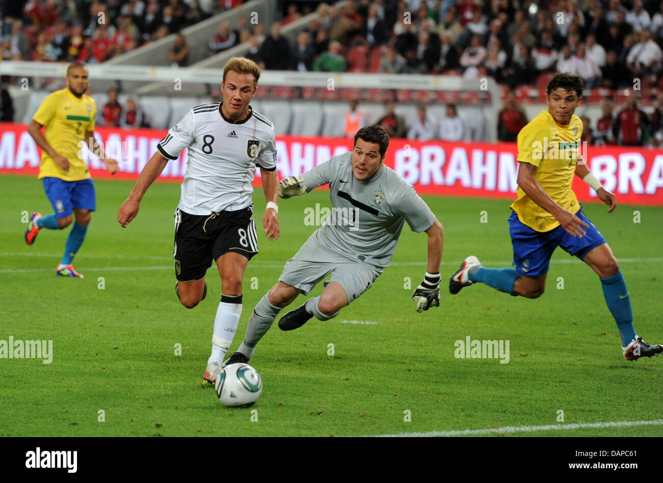 Germany's Mario Goetze (2-L) scores the 2-0 lead against Brazil's goalkeeper Julio Cesar (2-R) during the international friendly soccer match Germany vs Brazil at Mercedes-Benz Arena in Stuttgart, Germany, 10 August 2011. Foto: Uli Deck dpa/lswy  +++(c) dpa - Bildfunk+++ Stock Photo