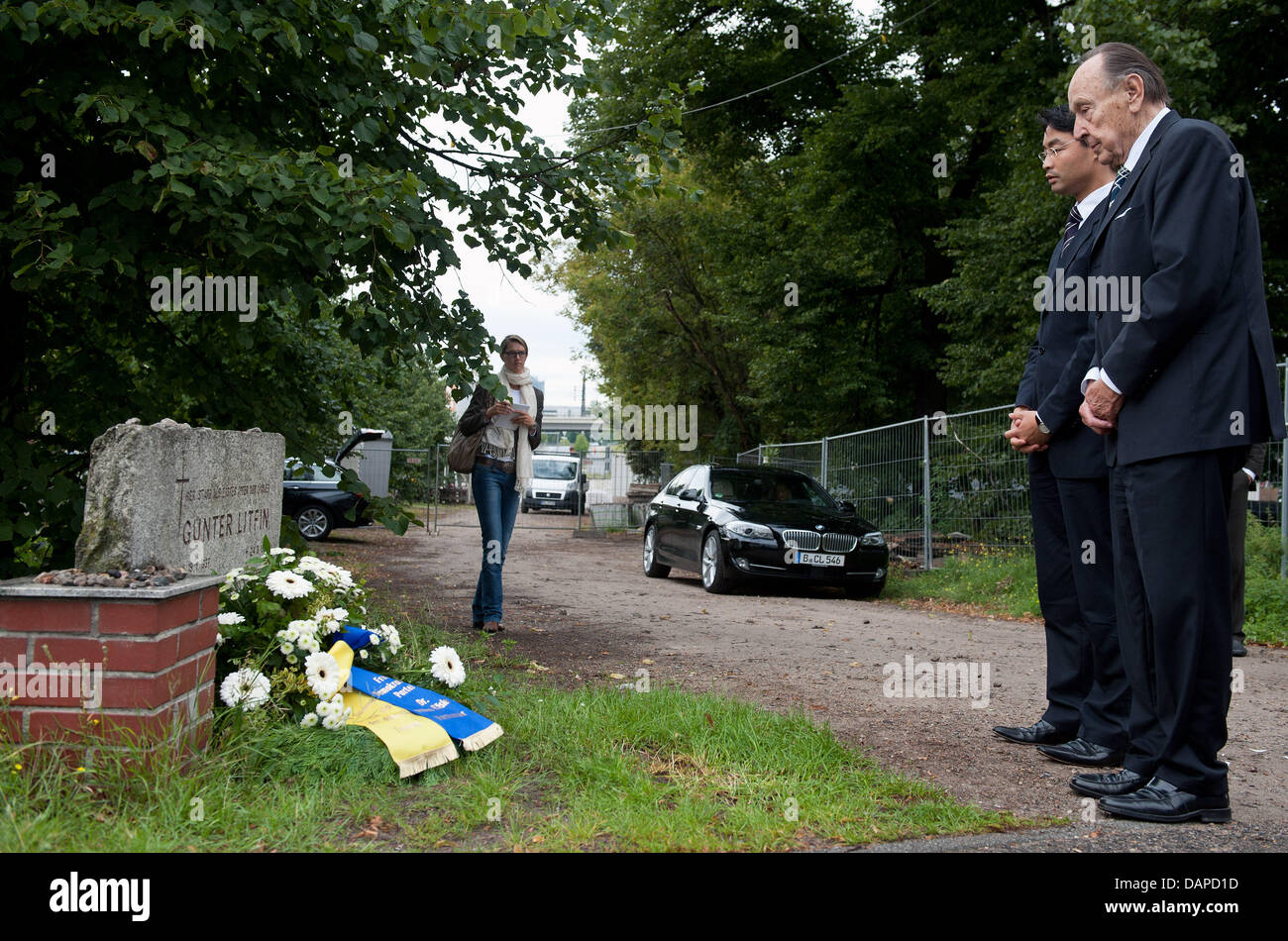 The former foreign minister and today's honorary FDP chair Hans-Dietrich Genscher (R) and FDP chairman and Economy Minister Philipp Roesler lay down a wreath at the memorial stone of Guenter Litfin at the Sandkrug bridge in Berlin, Germany, 12 August 2011. They wish to remember the victims of the Berlin Wall, which was constructed 50 years ago on 13 August 1961. Photo: HANNIBAL Stock Photo