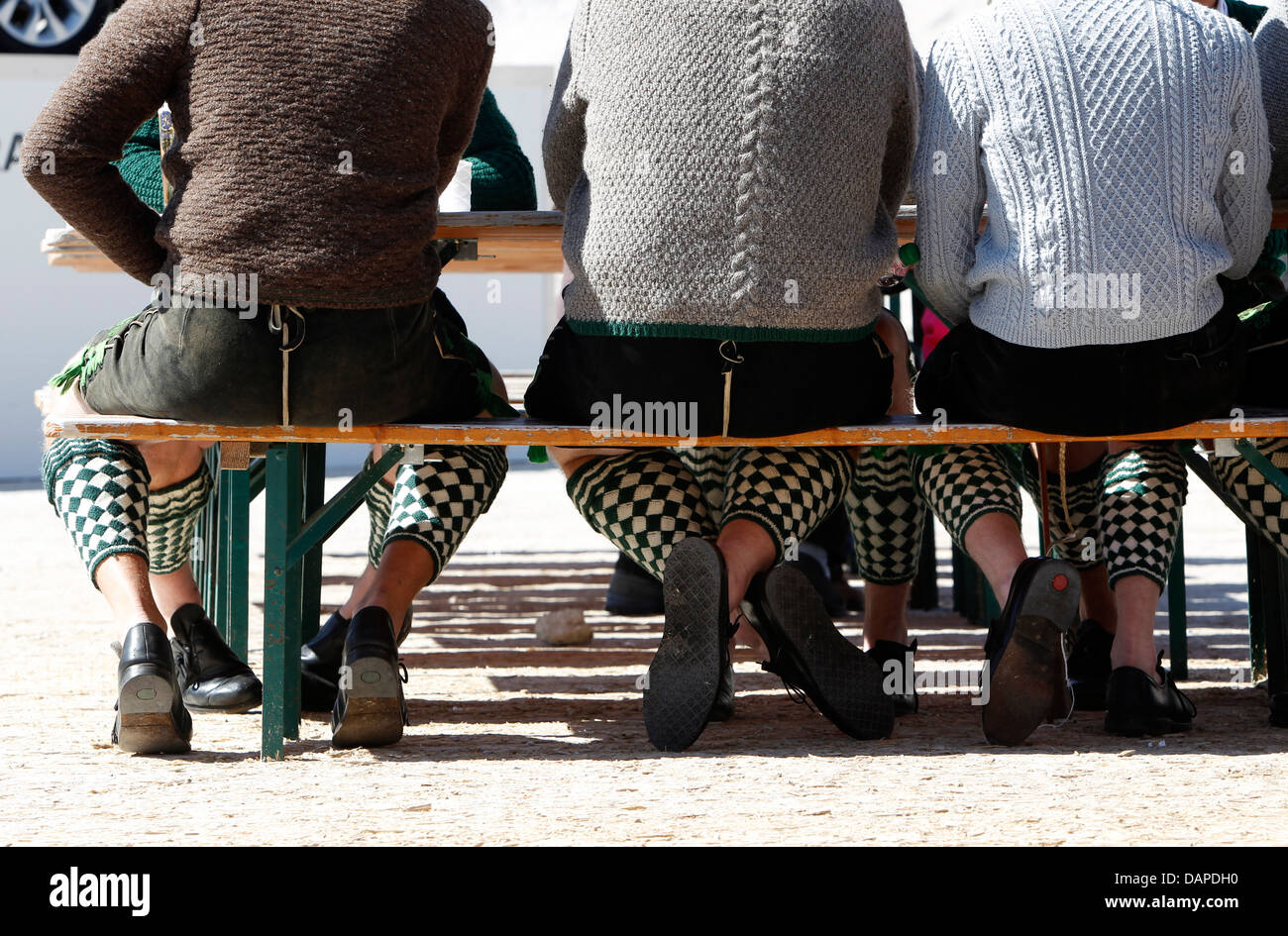 Germany, Men in traditional clothing sitting on bench Stock Photo Alamy