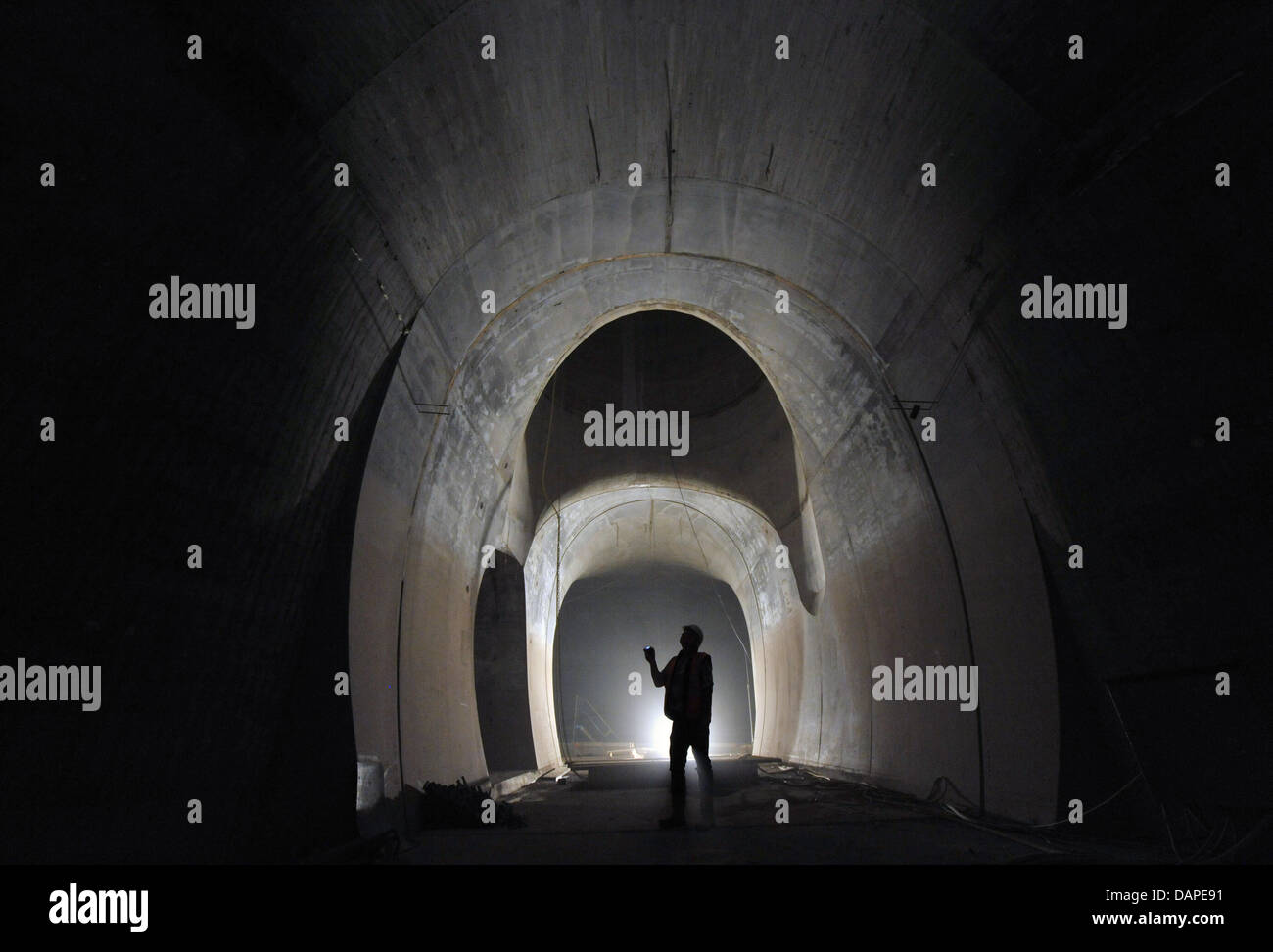An engineer checks a ventilation shaft of the Jadgbergtunnel near Jena, Germany, 09 August 2011. The three kilometre long tunnel system belongs to a bypass road that is being built to avoid traffic at the natural reserve Leutratal. The route is planned to be finished by mid 2013. Photo: Martin Schutt Stock Photo