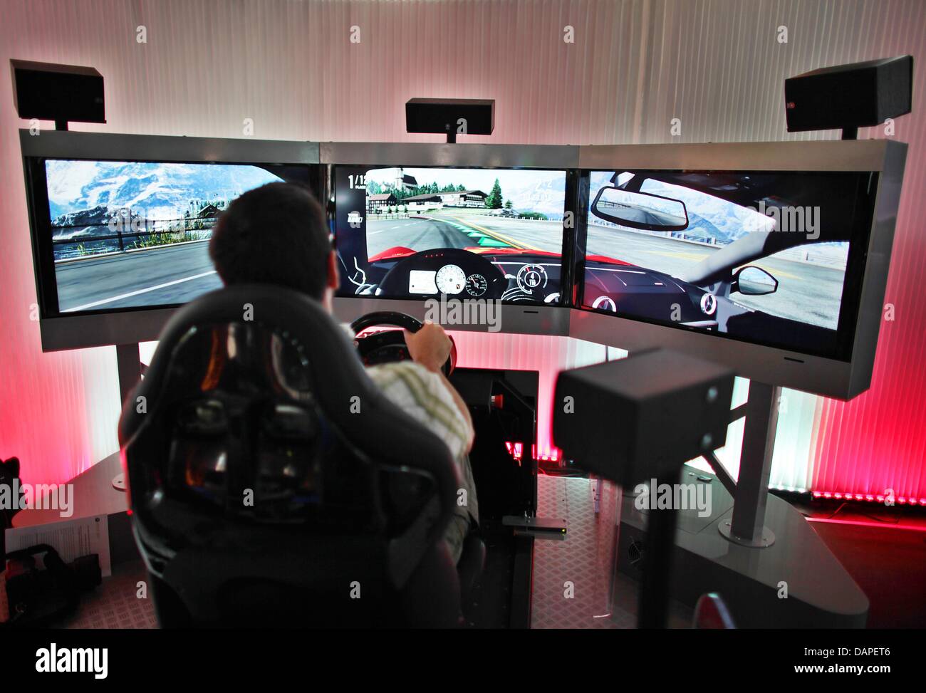 A man plays a racing game during a presentation (Microsoft xbox) of the Gamescom in Cologne, Germany, 16 August 2011. The fair for interactive games and entertainment Gamescom starts on 17 August 2011 and will be a paradise for computer gamers. Photo: OLIVER BERG Stock Photo
