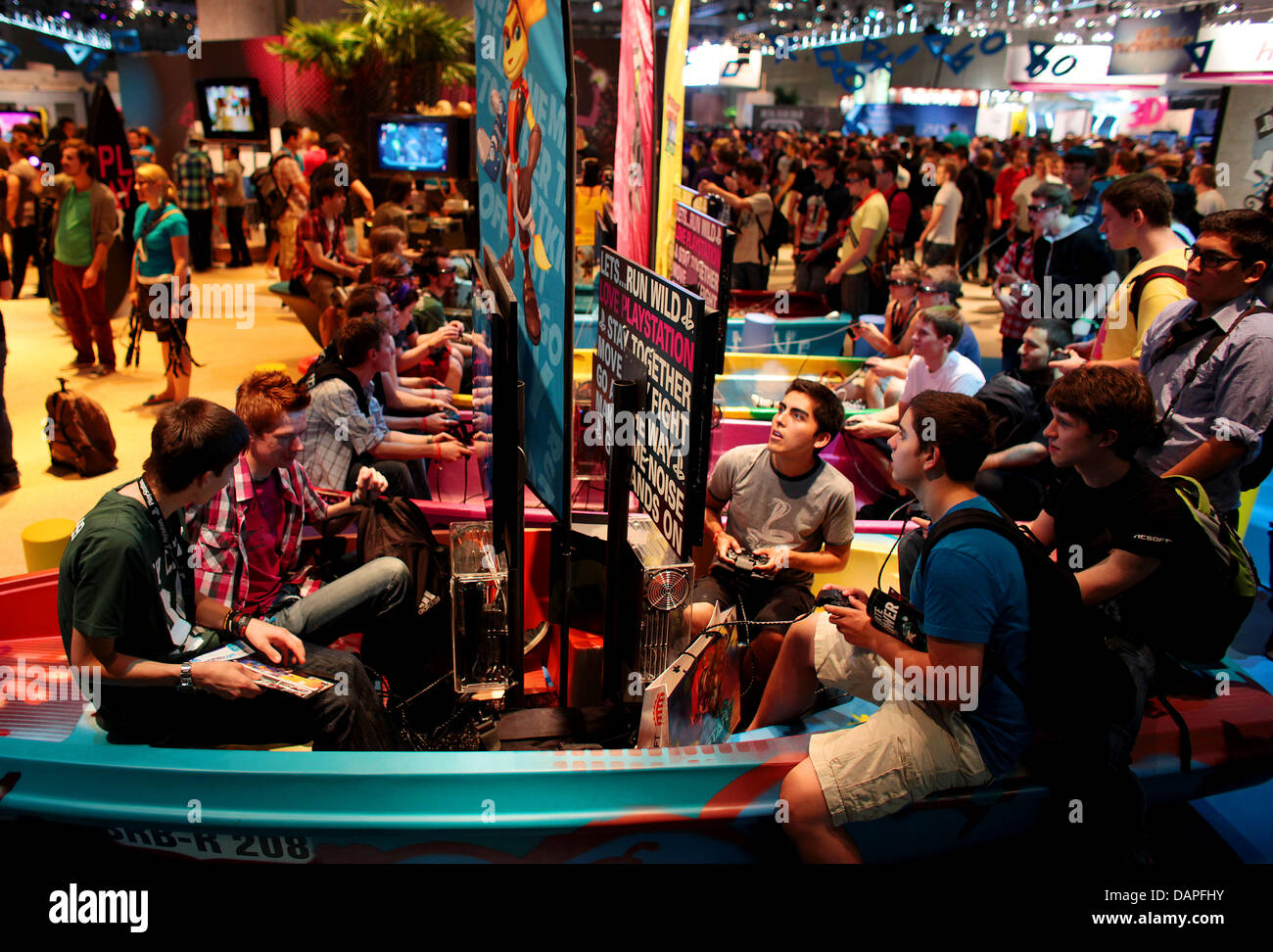 Visitors of the trade fair for video games Gamescom  crowd in front of computer screens and thereby sit in boats in Cologne, Germany, 18 August 2011. The world's largest games event opened its doors to the public on 18 August 2011. Photo: Oliver Berg Stock Photo
