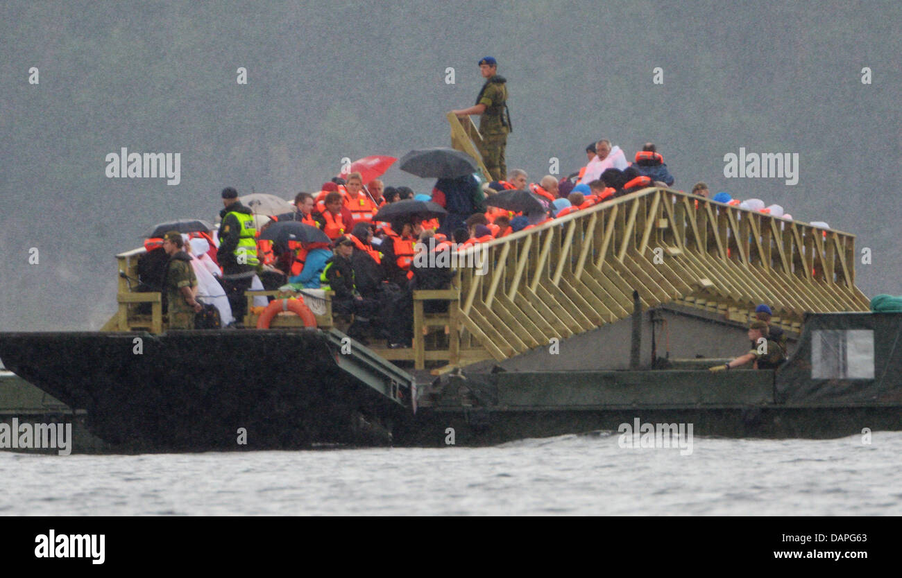 Relatives of the victims that died in the shooting stand on a ferry to