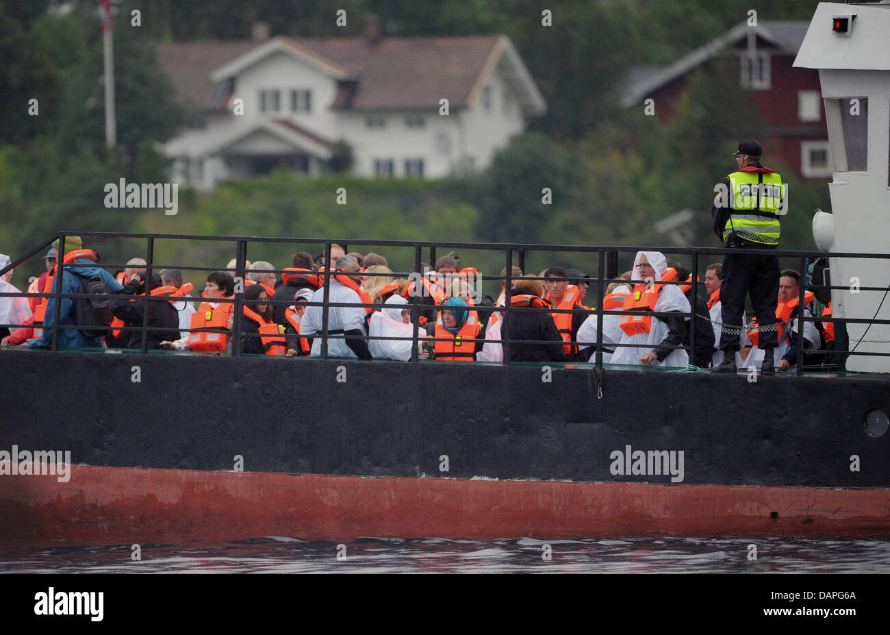 Relatives of the victims that died in the shooting stand on a ferry to