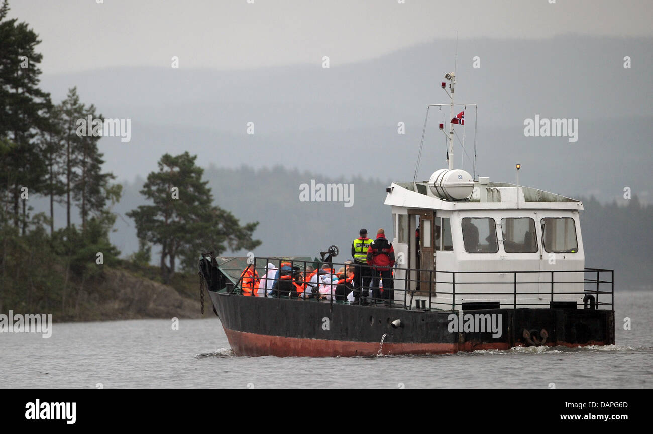 Relatives of the victims that died in the shooting stand on a ferry to