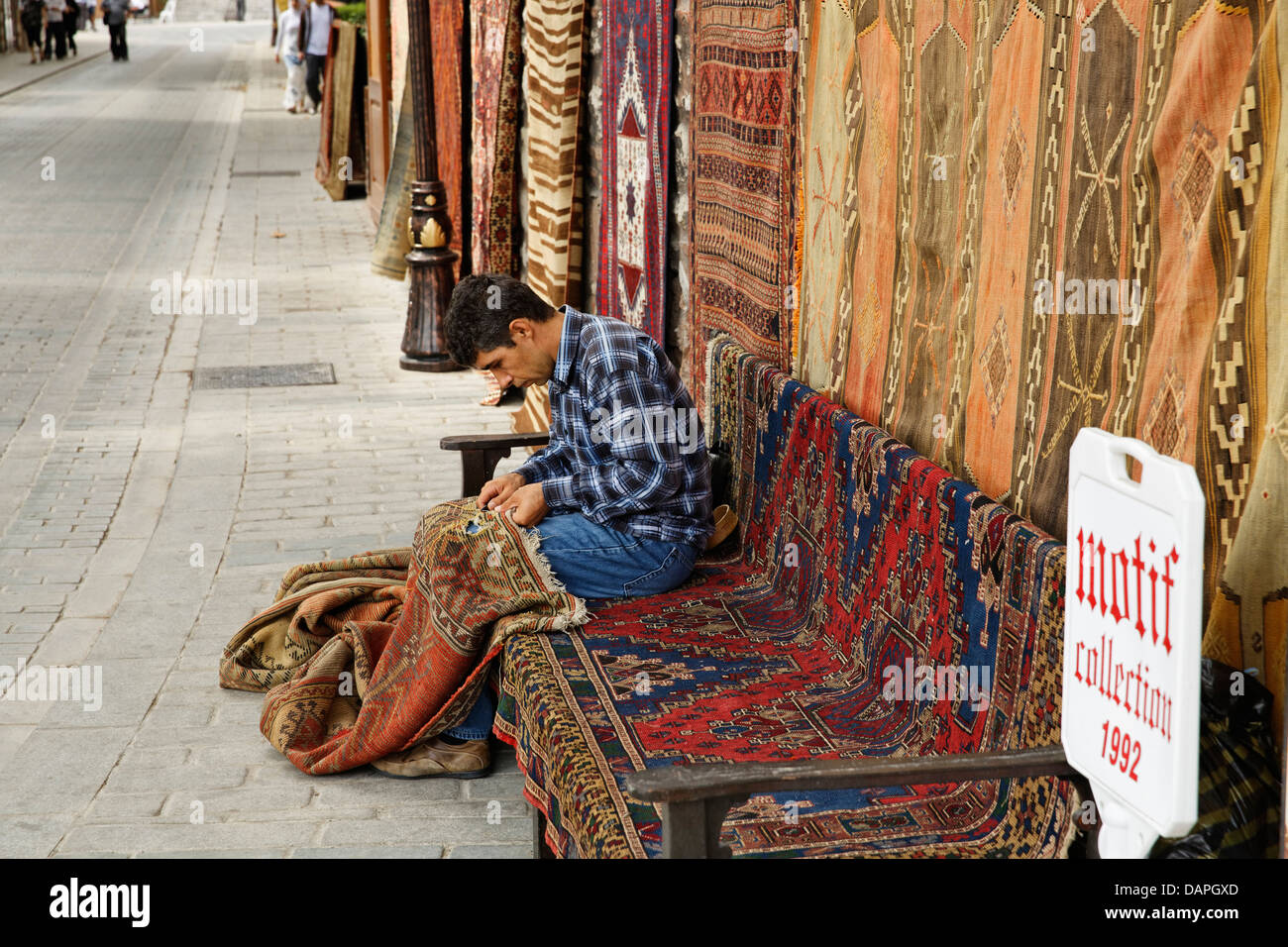 Europe, Turkey, Istanbul, Man stitching carpet Stock Photo