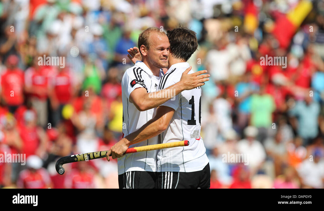 Germany's Thilo Stralkowski (L) cheers with his teammate  Jan-Marco Montag after the Montag's final 3-1 goal during the men's Hockey European Championship Group A match at Hockey-Park in Moenchengladbach, Germany, 20 August 2011. Germany won 3-1. Photo: Fabian Stratenschulte Stock Photo