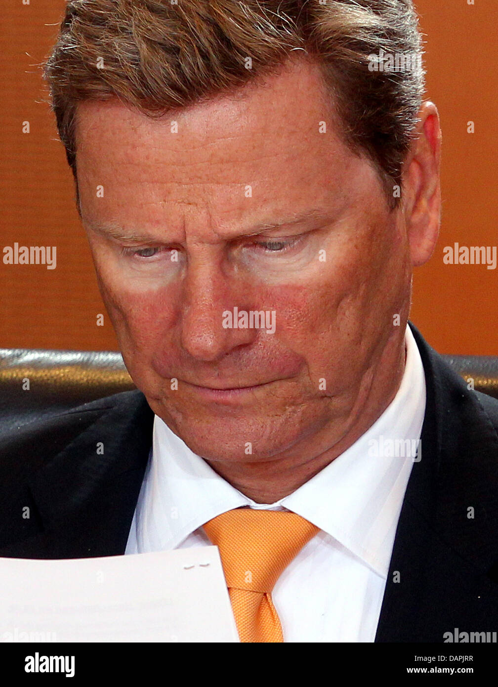 German Foreign Minister Guido Westerwelle reads with shade-impaired light rings around his eyes at a cabinet meeting at the Chancellery in Berlin, Germany, 24 August 2011. Among other issues, the cabinet will discuss internet security measures for electronic payment transactions. Photo: Wolfgang Kumm Stock Photo