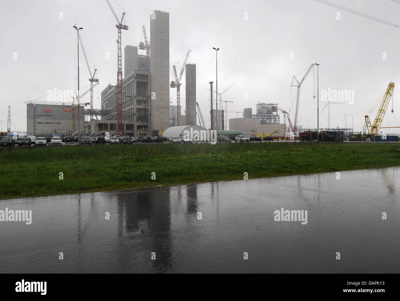 Low hanging rain clouds hang over the shell of the new coal power plant ...