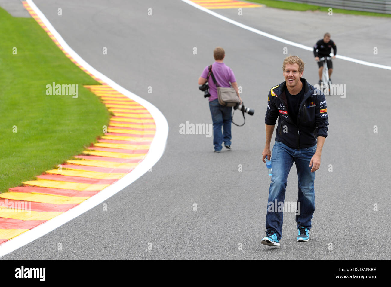 German Formula One driver Sebastian Vettel of Red Bull walks up the Eau Rouge corner at the race track Circuit de Spa-Francorchamps near Spa, Belgium, 25 August 2011. The Formula One Grand Prix of Belgium will take place on 28 August 2011. Photo: David Ebener Stock Photo