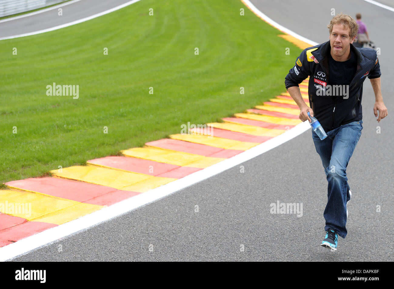 German Formula One driver Sebastian Vettel of Red Bull walks up the Eau Rouge corner at the race track Circuit de Spa-Francorchamps near Spa, Belgium, 25 August 2011. The Formula One Grand Prix of Belgium will take place on 28 August 2011. Photo: David Ebener Stock Photo