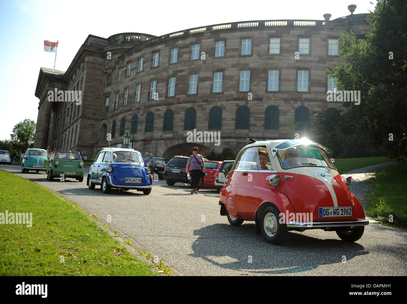 BMW Isettas drive past Wilhelmshoehe Palace in Kassel, Germany, 24 August 2011. The classic cars from the 1950s and early 60s drive to the Isetta meeting at Sensenstein which takes place on the weekend of 27 and 28 August. Around 150 Isettas are expected to participate. Photo: Uwe Zucchi Stock Photo