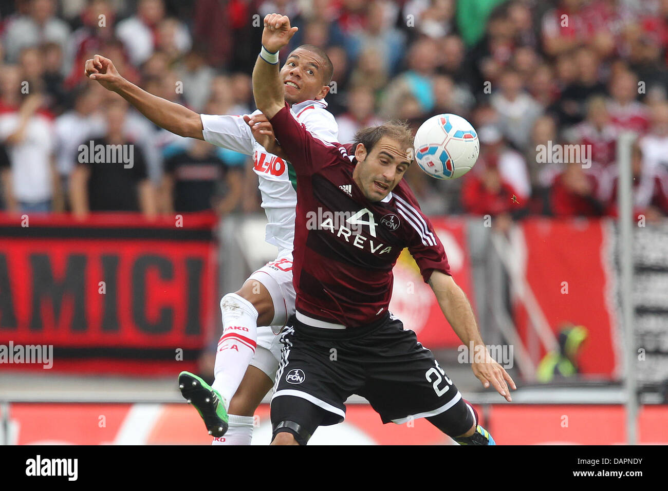 Nuremberg's Javier Horacio Pinola (R) vies for the ball with Augsburg's Marcel Ndjeng during the German Bundesliga match 1st FC Nuremberg vs FC Augsburg at the easyCredit Stadium in Nuremberg, Germany, 27 August 2011. Nuremberg won by 1-0. Photo: DANIEL KARMANN  (ATTENTION: EMBARGO CONDITIONS! The DFL permits the further utilisation of the pictures in IPTV, mobile services and othe Stock Photo