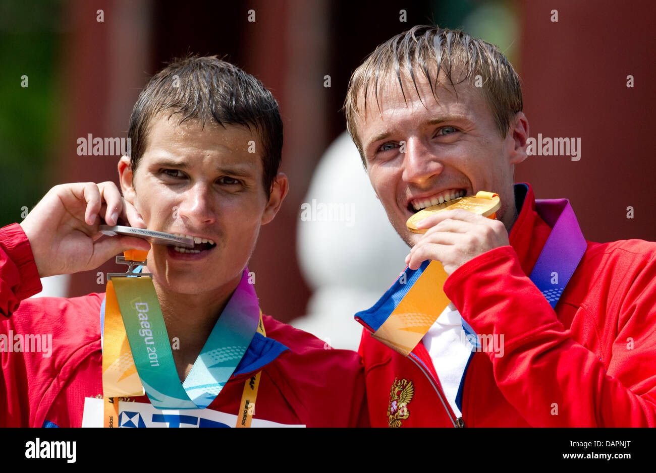 Winner Valeriy Borchin (R) of Russia and his compatriot Vladimir Kanaykin show their medals for finishing first and second place in the Men's 20 Kilometres Race Walk of the 13th IAAF World Championships in Daegu, Republic of Korea, 28 August 2011. Kanaykin ranked second. Photo: Bernd Thissen dpa Stock Photo