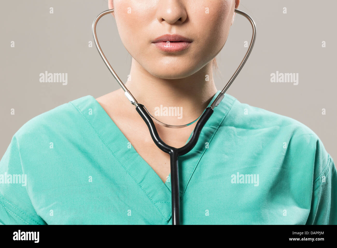 Young attractive nurde with stethoscope and headphones and microphone.  Isolated on white Stock Photo - Alamy