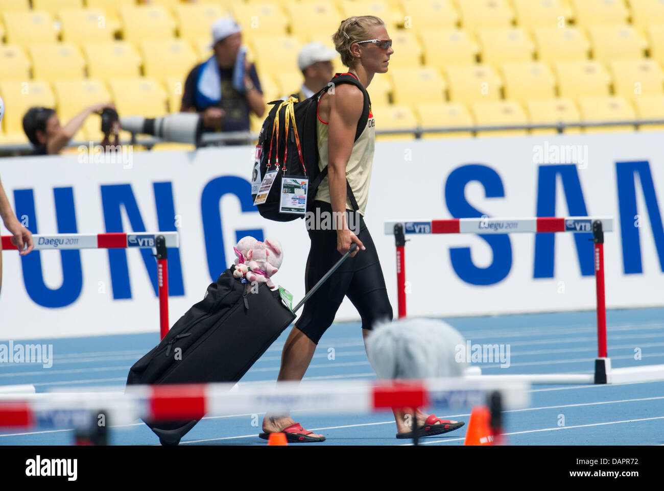 Jennifer Oeser of Germany leaves the stadium after participating in the womens High Jump event of the Heptathlon competition at the 13th IAAF World Championships in Athletics, in Daegu, Republic of Korea, 29 August 2011. Photo: Bernd Thissen dpa Stock Photo
