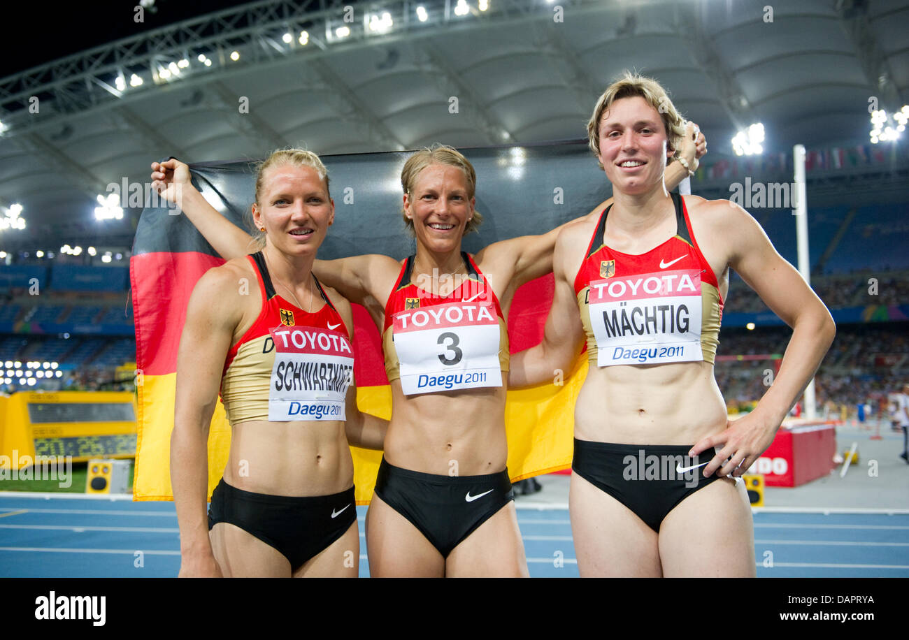 Lilli Schwarzkopf (l-r), Jennifer Oeser and Julia Mächtig of Germany celebrate after the Women's Heptathlon at the 13th IAAF World Championships in Athletics, in Daegu, Republic of Korea, 30 August 2011. Photo: Bernd Thissen dpa  +++(c) dpa - Bildfunk+++ Stock Photo