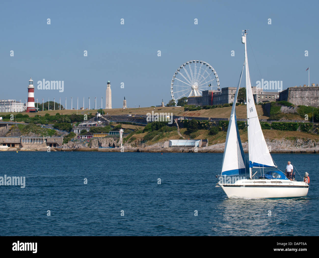 Yacht on the Plym Estuary going past Plymouth Hoe and the Smeaton's Tower, UK Stock Photo