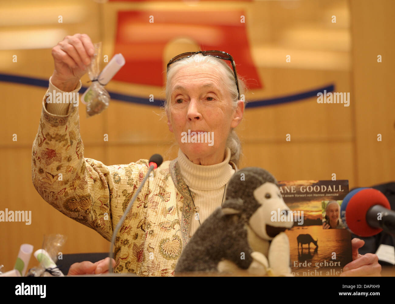 British primatologist Jane Goodall holds chimpanzee toy and a bag