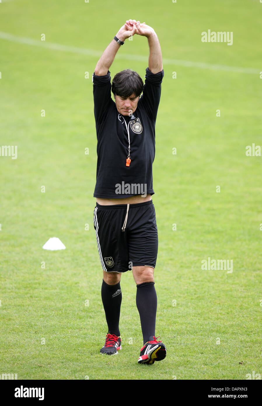 German national soccer team coach Joachim Loew stretches during a practice session at Paul Janes Stadium in Duesseldorf, Germany, 04 September 2011. On 06 September 2011, Germany will play Poland in a friendly match in Gdansk, Poland. Photo: Rolf Vennenbernd Stock Photo