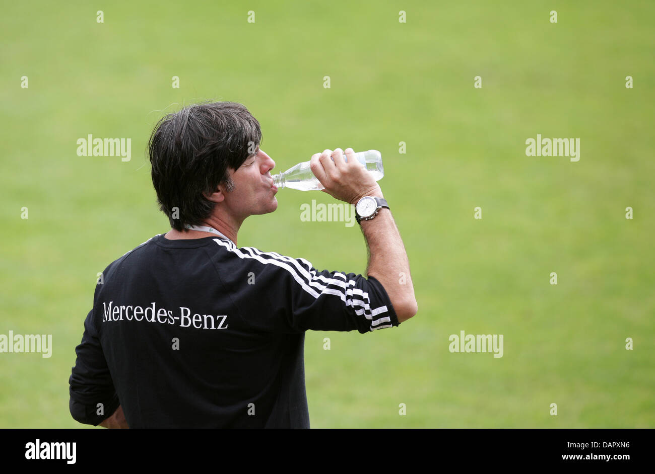 German national soccer team coach Joachim Loew drinks water during a practice session at Paul Janes Stadium in Duesseldorf, Germany, 04 September 2011. On 06 September 2011, Germany will play Poland in a friendly match in Gdansk, Poland. Photo: Rolf Vennenbernd Stock Photo